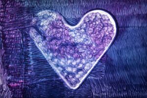 a heart - shaped object is shown on a purple background