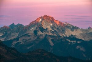 Majestic mountain peak illuminated by sunrise light.